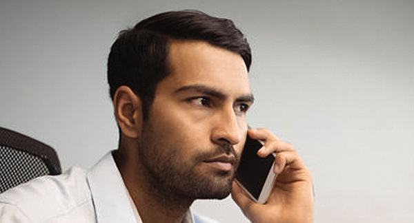 A photo of a bank customer speaking on a mobile.