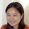 A photo of a woman with long straight hair.