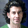 A photo of a man with curly hair. 