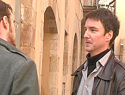 A phot of two friends meeting in the street.