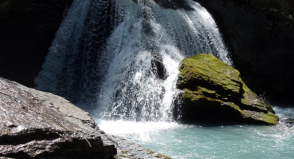 A photo of a waterfall and a rock pool. 