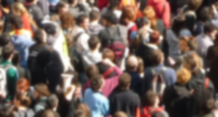 A blurred photo of a large crowd of people. 