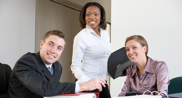 A photo of three people conducting a job interview.