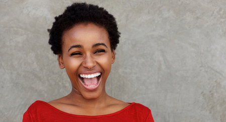A photo of a woman laughing. 