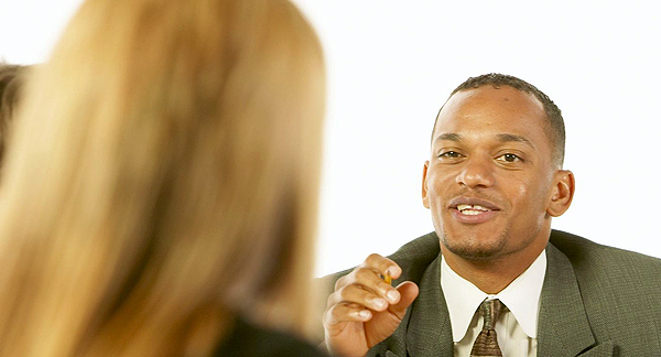 A photo of a man and woman discussing work in an office.