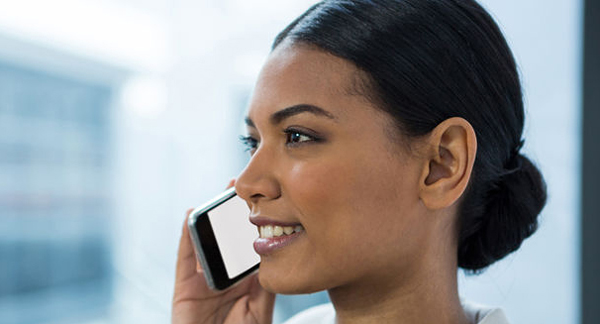 A photo of a woman speaking on a mobile.