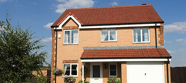 A photo of a two-storey house in a suburban setting. 