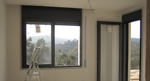 A photo of the interior of a wooden house that is under construction.