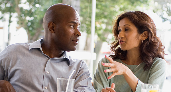 A photo of a man and woman discussing something. 