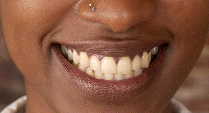 A close-up photo of a woman smiling. 