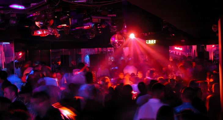 A photo of people dancing in a crowded disco.  