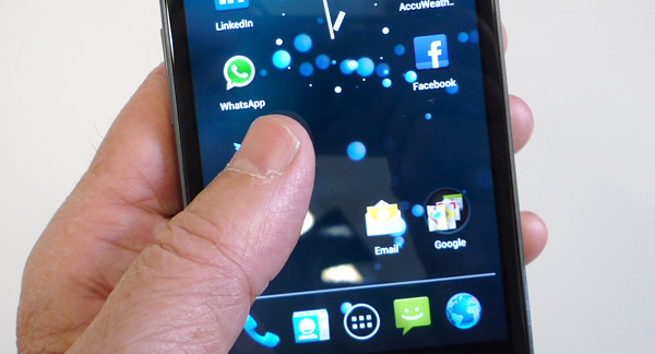 A photo of a hand holding a mobile phone.