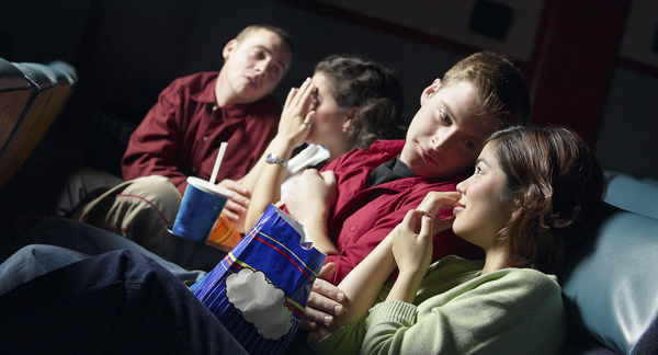 A photo of teenagers in a cinema. 