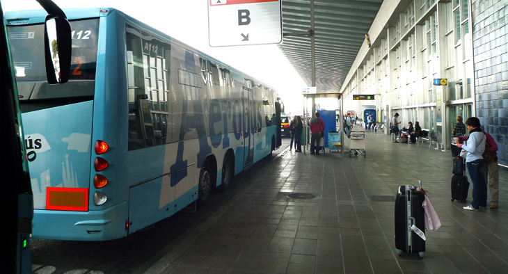 A photo of an airport bus at the airport.