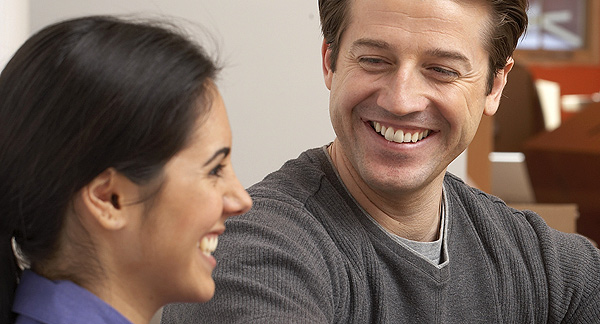 A photo of a woman and man chatting casually. 