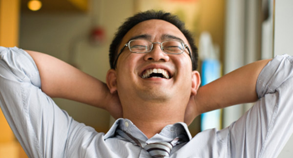 A photo of a man laughing heartily. 