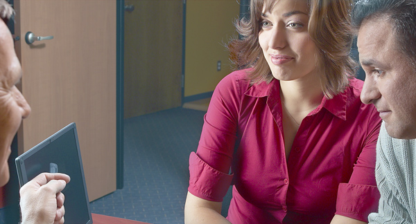 Bank customers and an employee having a conversation in a bank.